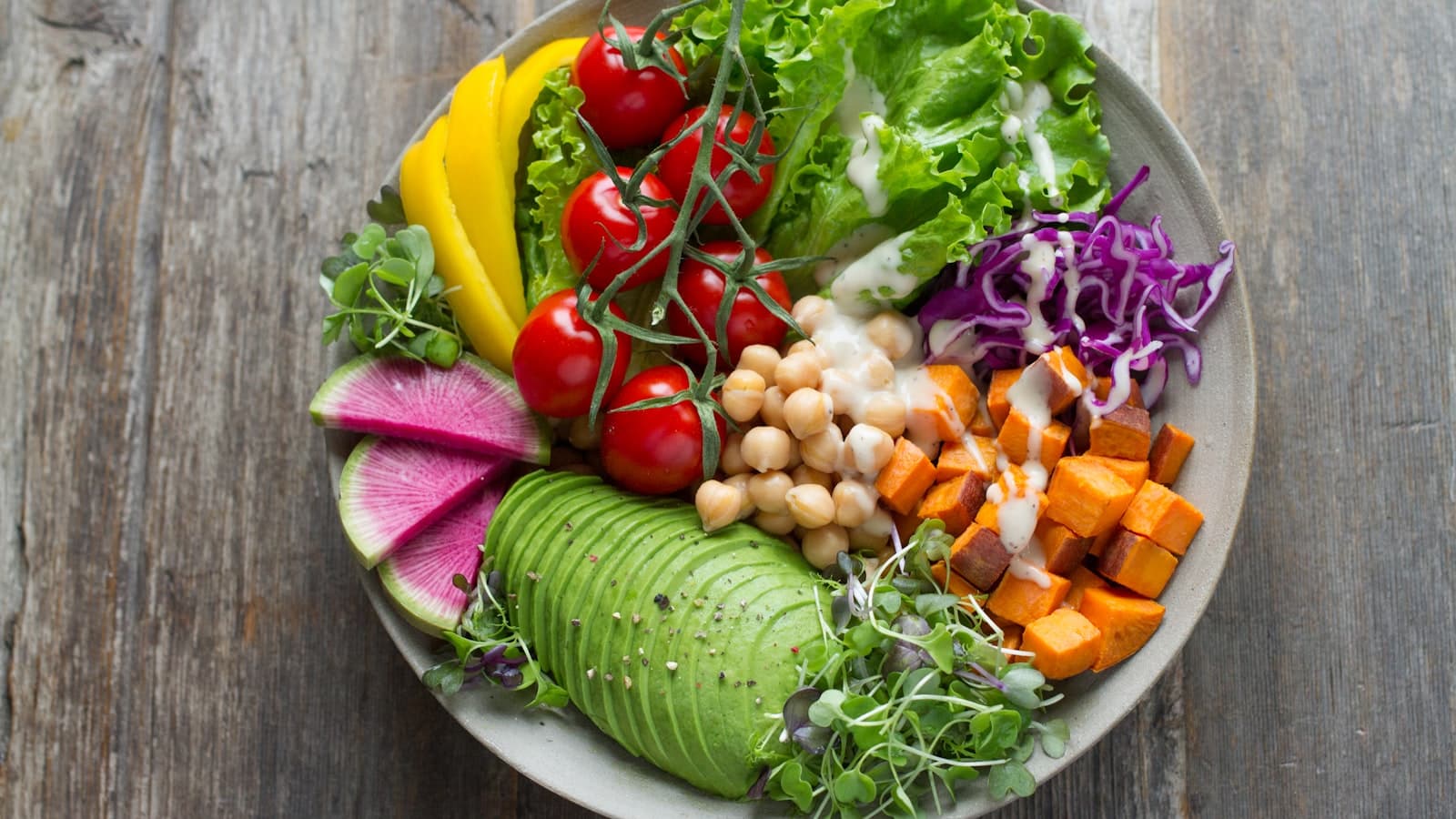 Colorful healthy bowl with vegetables and greens photographed from above